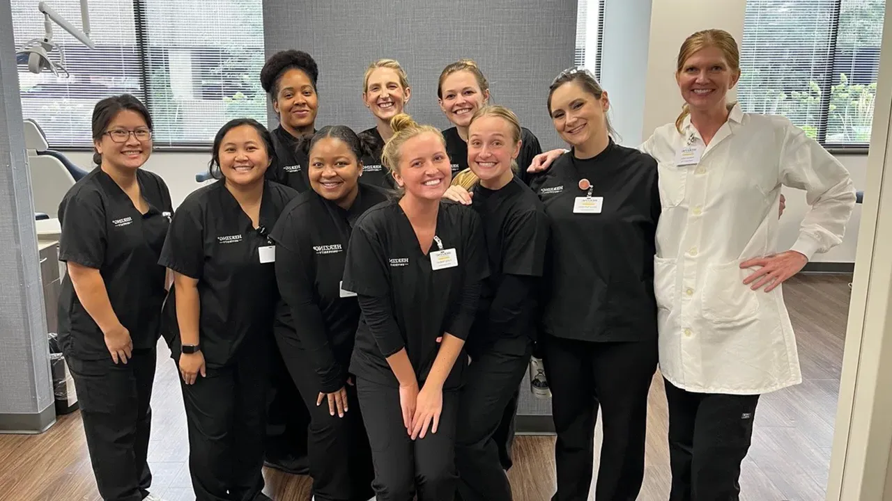 Herzing Dental Hygiene students with their instructor pose for a photograph